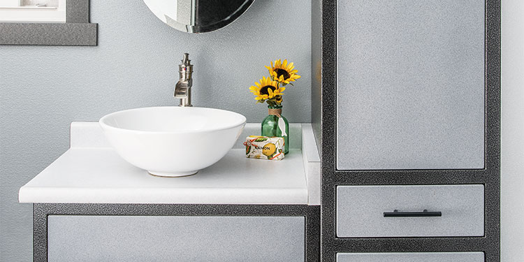 Rock Run Cabinetry Aluminum Bathroom Cabinets shown in Blue Speckle and Silvervein